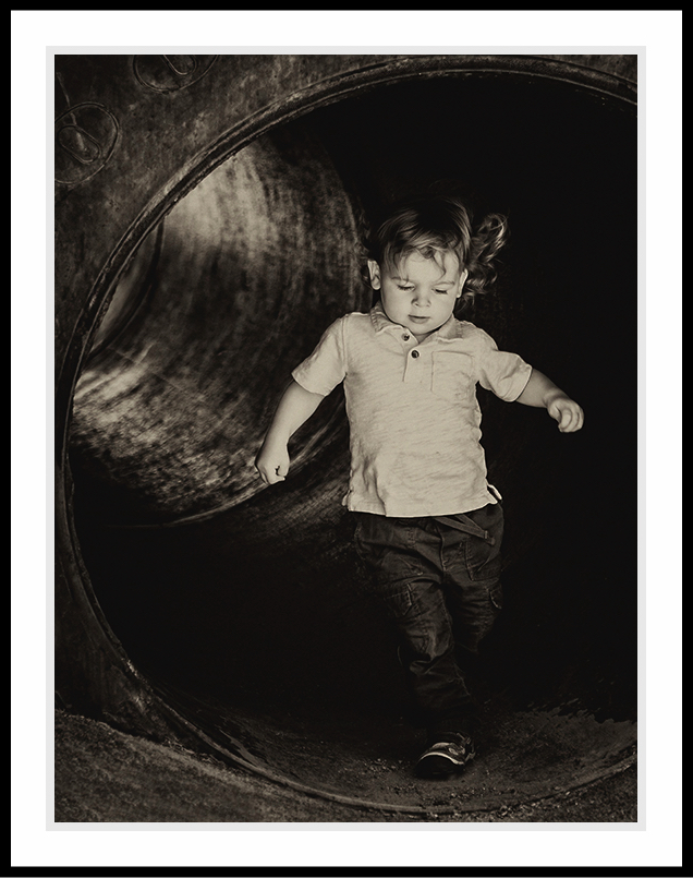 Boy having fun walking through a tunnel.